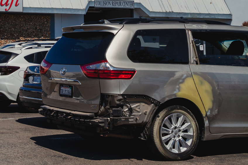 A car waiting for repair at a body shop in San Rafael, CA